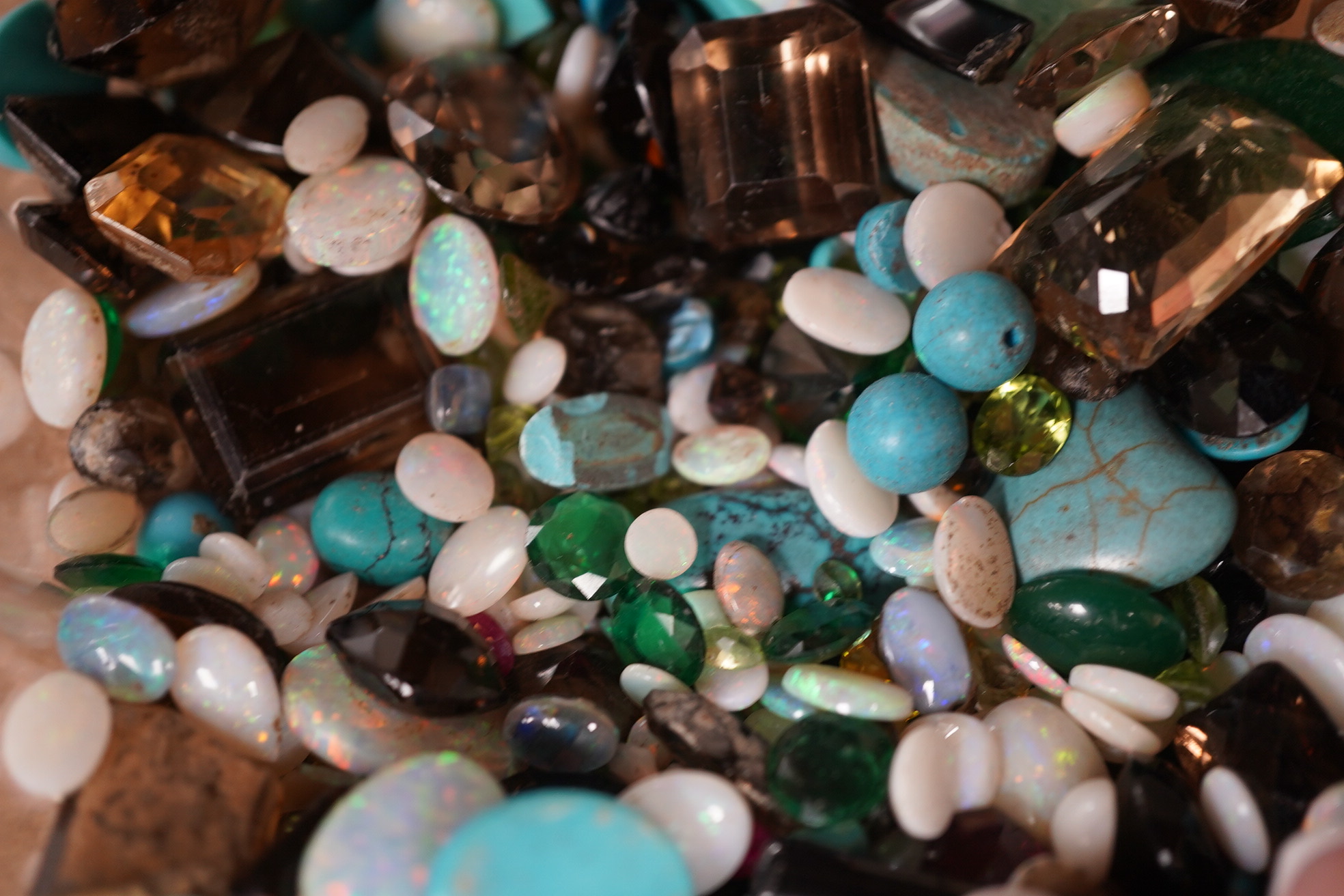 A large quantity of assorted unmounted cut and cabochon gemstones etc, including opal, quartz and turquoise. Condition - poor to fair to good